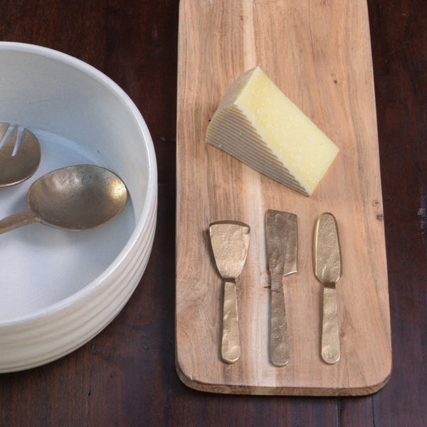 Cordoba Brass Finish Cheese Tools styled with cheese and board