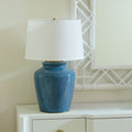 Aksel Cruise Teal Lamp styled on white chest