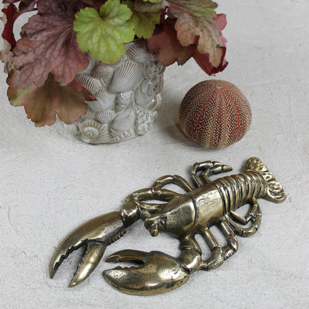 Antiqued Brass Finish Lobster styled with plant