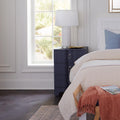 Biarritz Navy Grasscloth Side Table styled with white lamp in white bedroom