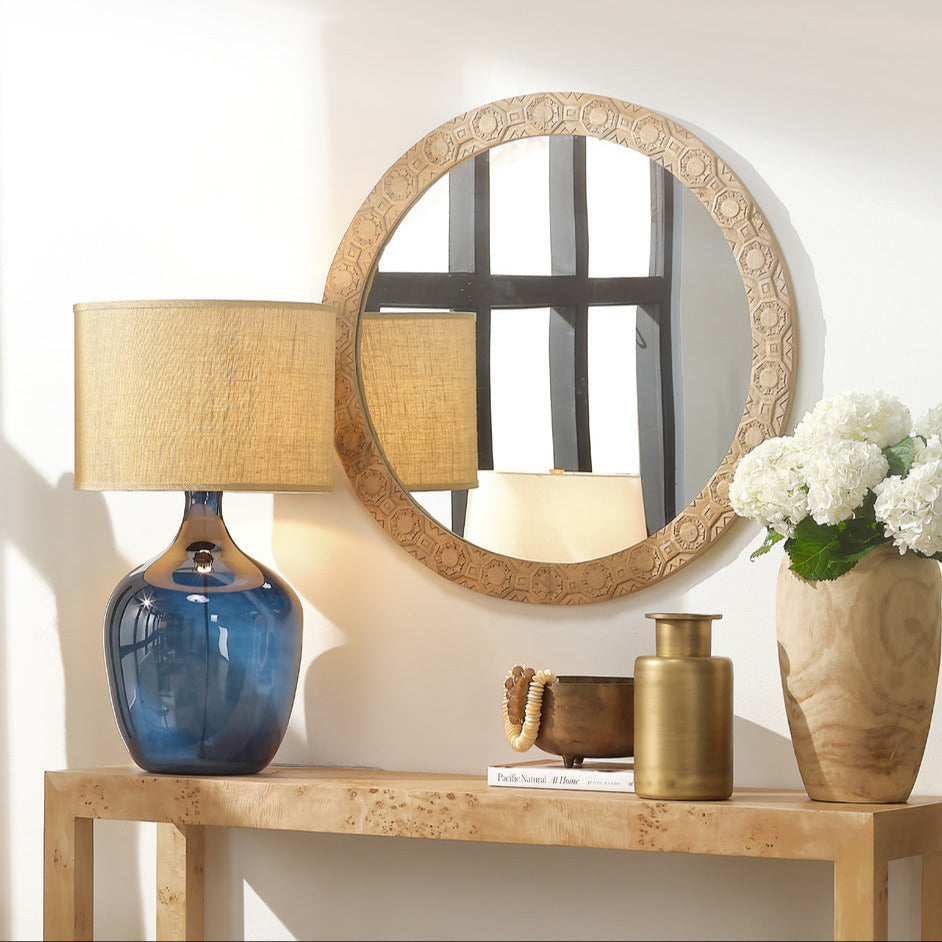 Navy Demi John Glass Lamp on burl console table with round mirror