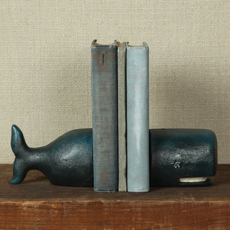 Blue Whale Cast Iron Bookends styled with vintage books on wood table