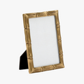 Bamboo-style brass photo frame on a white background
