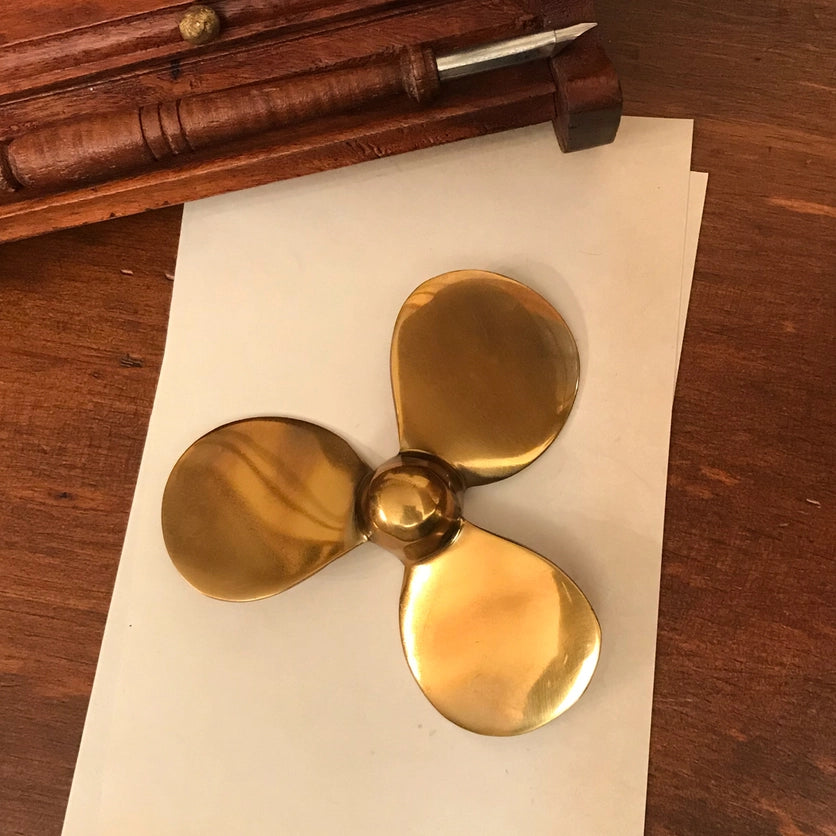 Brass Boat Propeller Paper Weight styled on desk