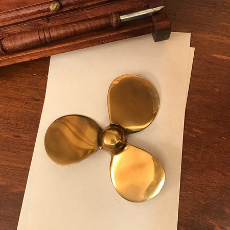 Brass Boat Propeller Paper Weight styled on desk