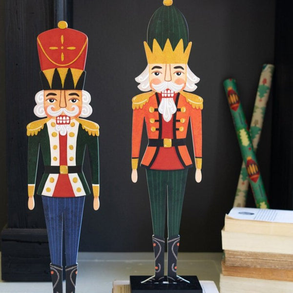 Colorful Pair of Wood Nutcrackers in front of black mantle