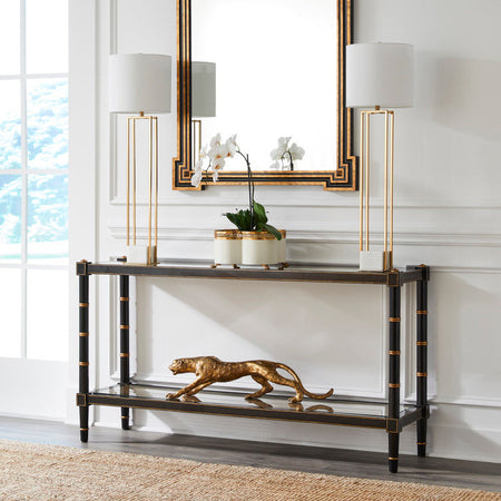Cabana Black Cane Console table with decorative items in a room with a large mirror and lamps.