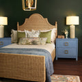 Calloway Woven Rattan Bed Styed in bedroom with blue grasscloth nightstands
