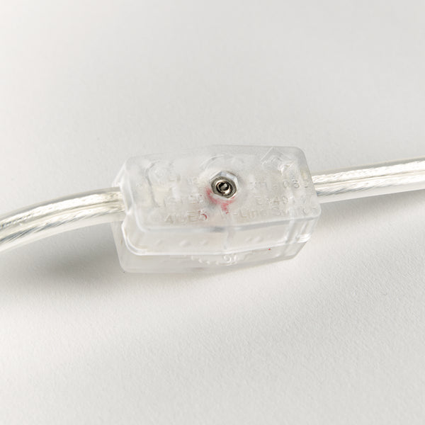 Clear electronic component with wires on a light gray background