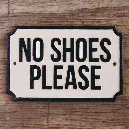 Cast Iron No Shoes Please Plaque on wood wall