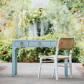 Castella Light Blue Lacquered Linen Desk in courtyard