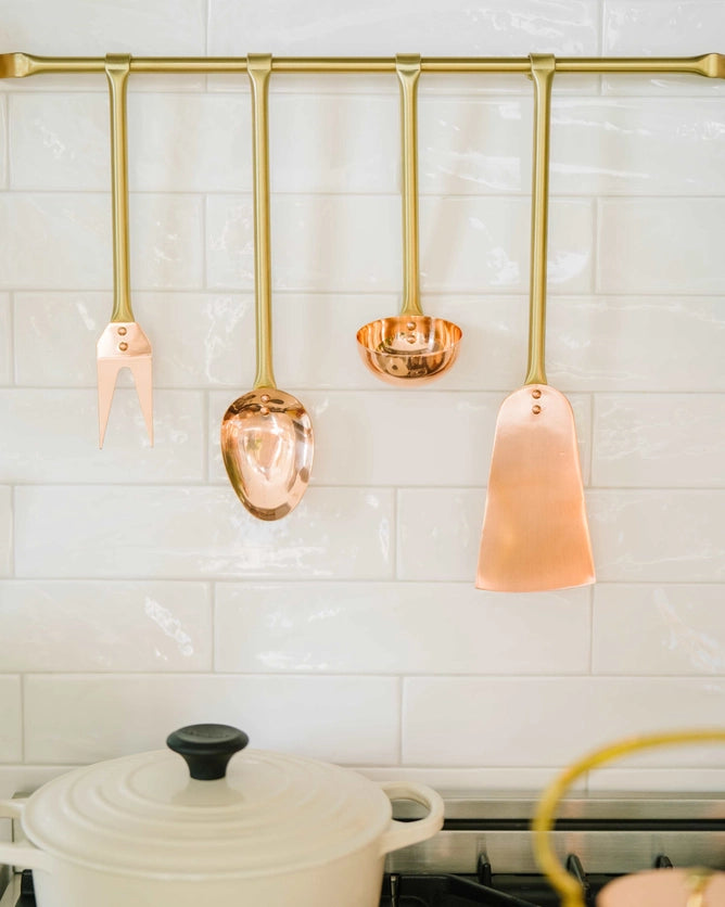 Copper Utensils on Brass Rod hanging above stove