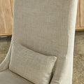 Beige Cora linen chair with a pillow against a wooden cabinet background