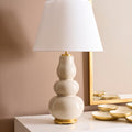 Daphne Sand Table Lamp styled on white cabinet