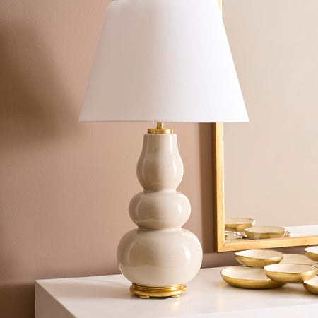 Daphne Sand Table Lamp styled on white cabinet