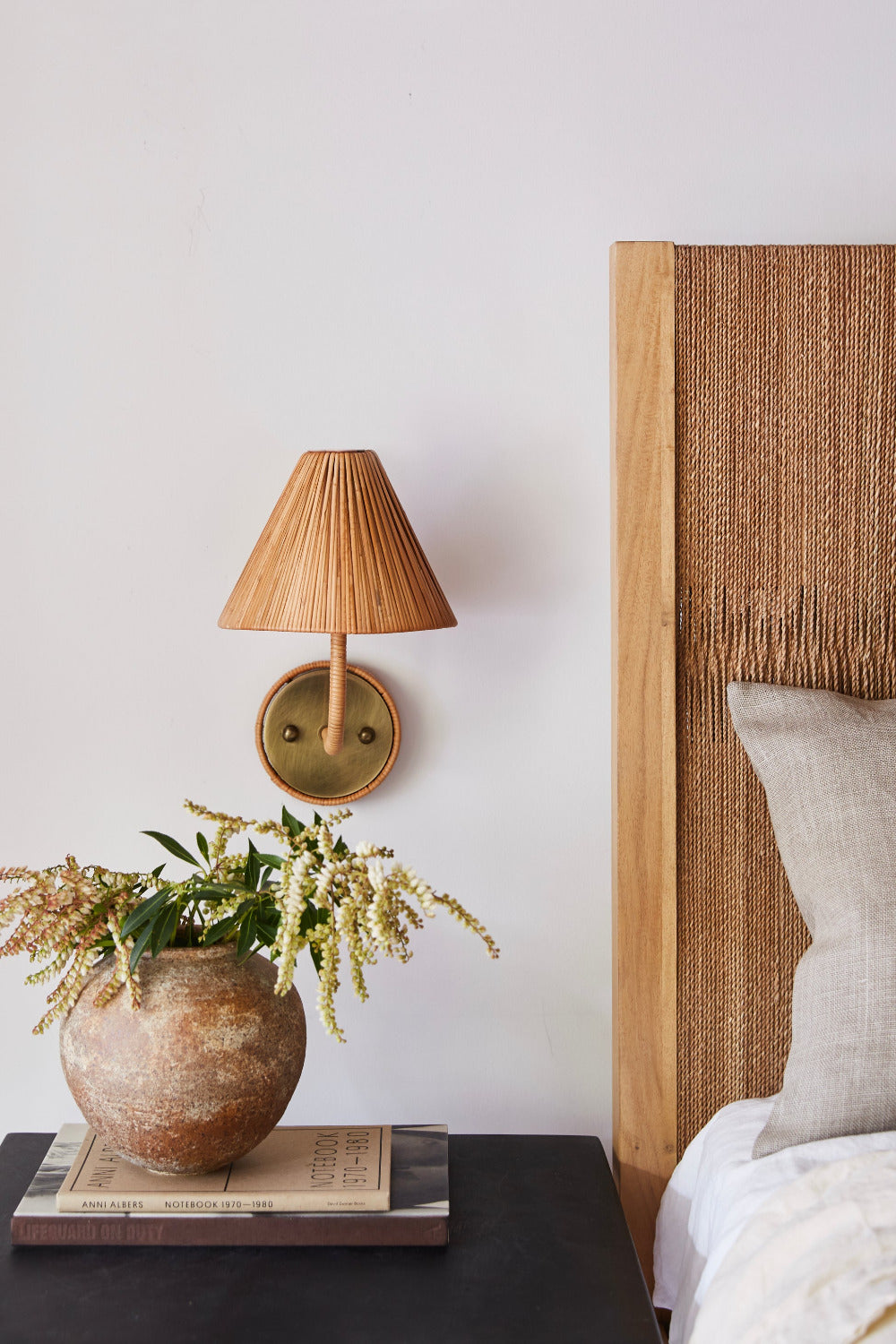 Delphine Rattan Wall Sconce styled in bedroom