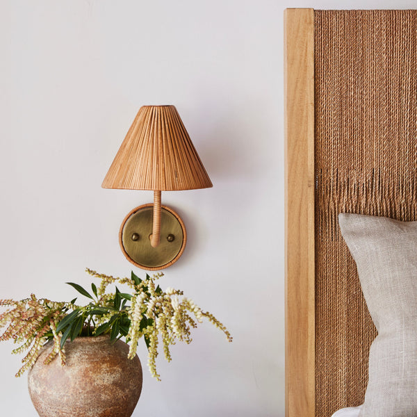 Delphine Rattan Wall Sconce styled in bedroom