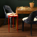 Deschamps Red Accent Table styled with burl game table