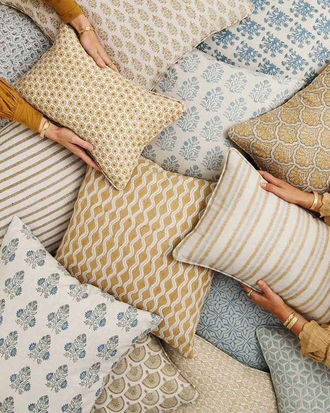 Etoile Saffron Lumbar Pillow Cover in pile of block print pillows