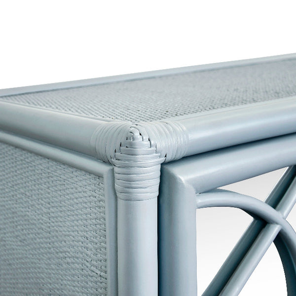 Close-up corner of light blue rattan cabinet showing woven rattan and frame