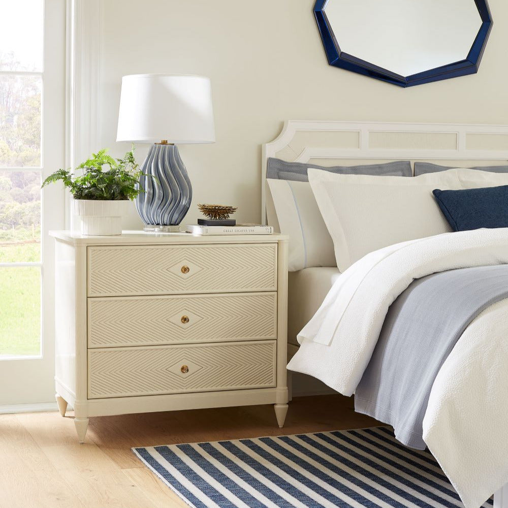 Flavie Three Drawer Nightstand styled in bedroom window