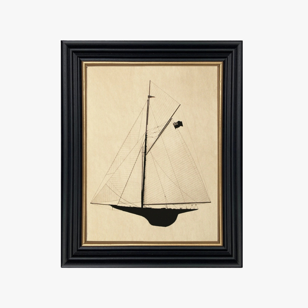 Framed artwork of a sailboat on beige paper with a black frame.