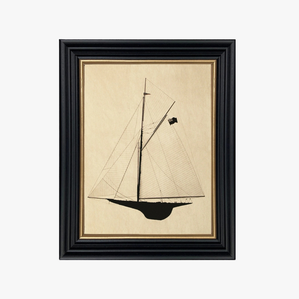 Framed artwork of a sailboat on beige paper with a black frame.