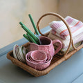 Garden Gathering Basket styled in kitchen with towels and dishes