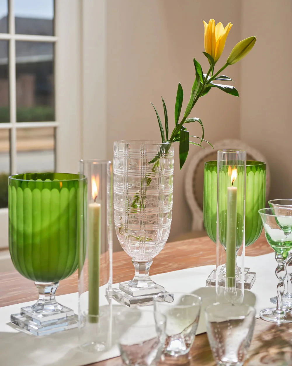 Green Glass Hurricanes styled on table