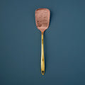 Hammered Copper Spatula on blue background