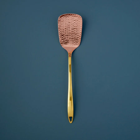 Hammered Copper Spatula on blue background