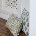 Hera Moss Celadon Lumbar Pillow Cover on wood bench