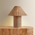 Jana Wicker Table Lamp illuminated on console table
