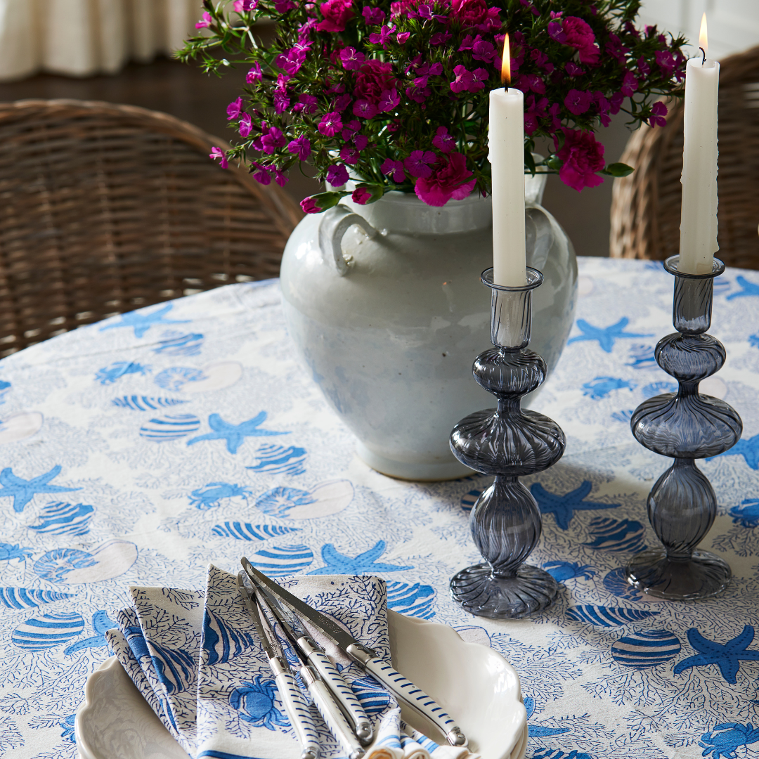 Joie Blue Glass Candlesticks styled on table with pink flowers