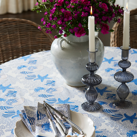 Joie Blue Glass Candlesticks styled on table with pink flowers