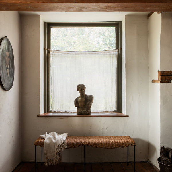 Lacoste Rattan Bench styled in front of window