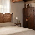 Lacoste Woven Rattan Bed  in moody bedroom