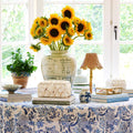 Lanai Bamboo Rechargeable Lamp styled on table with sunflowers in vase