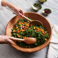 Large Mahogany Wood Salad Bowl with kale salad and marble salad severs