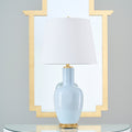 Leighton Sky Table Lamp in front of gold mirror