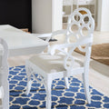 Loop white lacquer dining arm chair styled at end of  white table