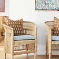 Lucknow Rattan Outdoor Pillow Cover styled in wicker chair