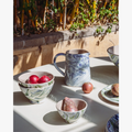 Marbled Ocean Bowl Set styled on outdoor table with pitcher