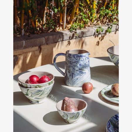 Marbled Ocean Bowl Set styled on outdoor table with pitcher