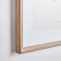 Wooden picture frame on a white wall