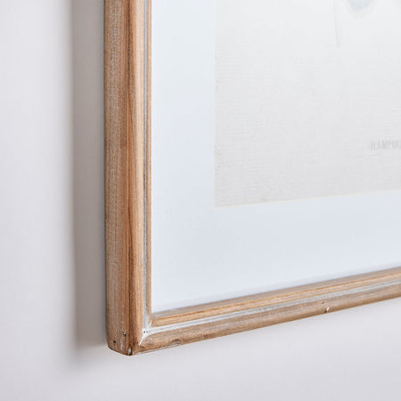 Wooden picture frame on a white wall