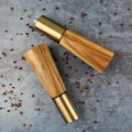Olive Wood Salt Shaker & Pepper Grinder Set styled with peppercorns