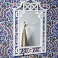 Pagoda White Lacquer Mirror on wallpapered wall
