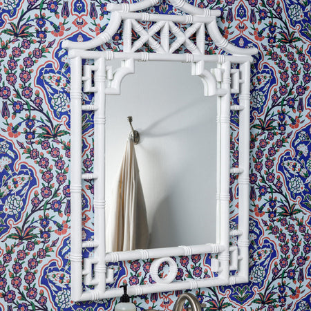 Pagoda White Lacquer Mirror on wallpapered wall
