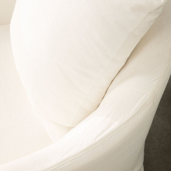 White curved chair with back pillow, angled